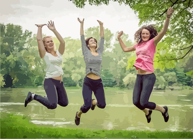 three women in mid-air, by a pond jumping for joy