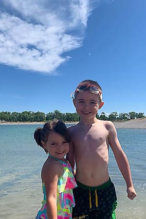 children swimming in a lake