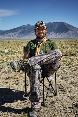 a hunter sitting in the desert